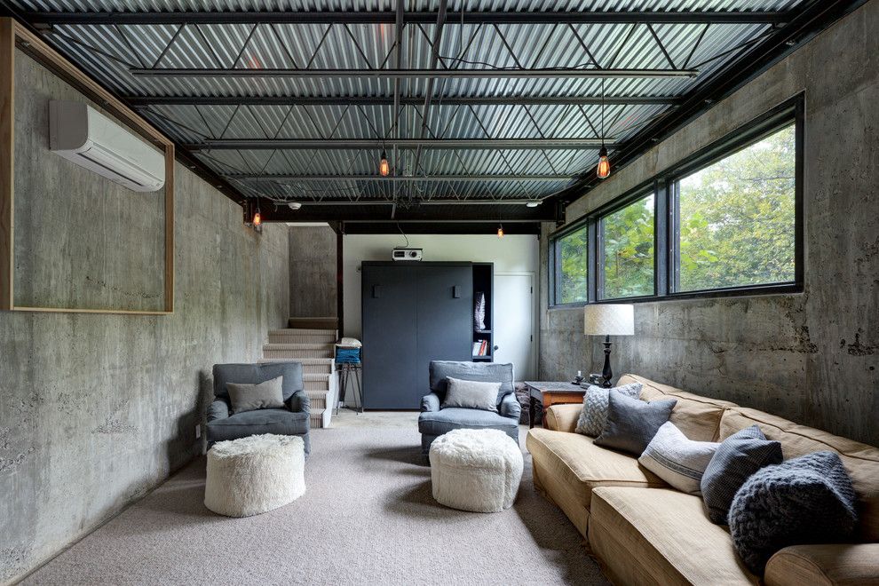 Gonzalez Furniture for a Industrial Basement with a White Drum Lamp Shade and Bouldin Creek Residence by Restructure Studio