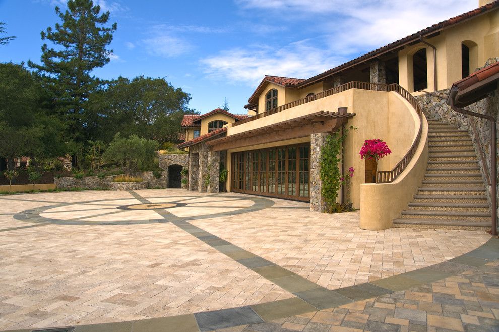 Hanover Pavers for a Mediterranean Exterior with a Trellis and Saratoga Estate by Kikuchi + Kankel Design Group