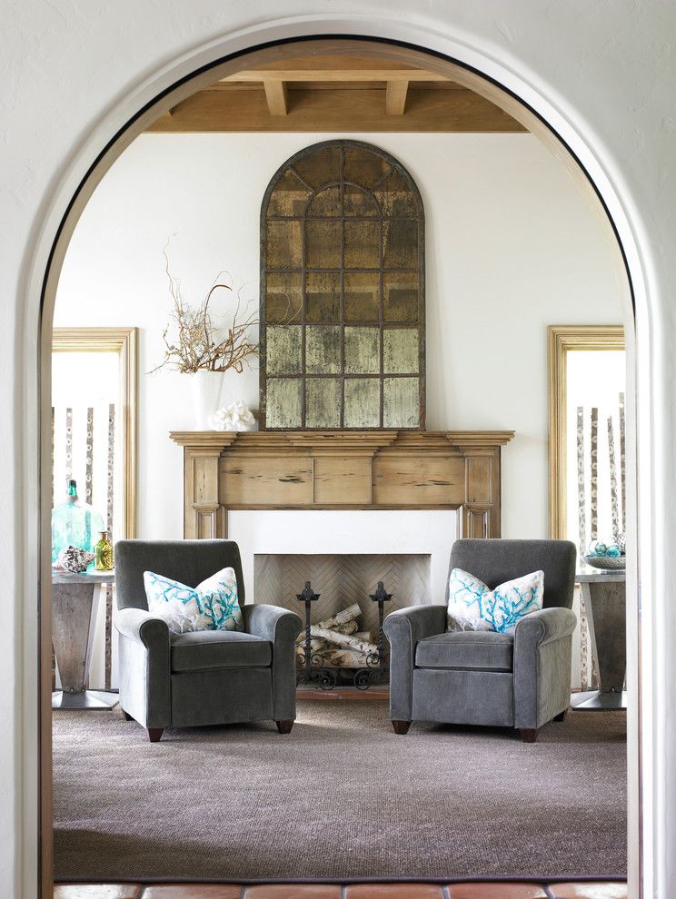 How to Decorate a Mantel for a Beach Style Entry with a White Fireplace Frame and Entry Sitting Area by Carter Kay Interiors