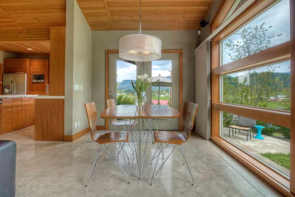 How to Stain Concrete Floors for a Modern Dining Room with a Green Walls and Modern Kitchen by Concept Builders, Inc.