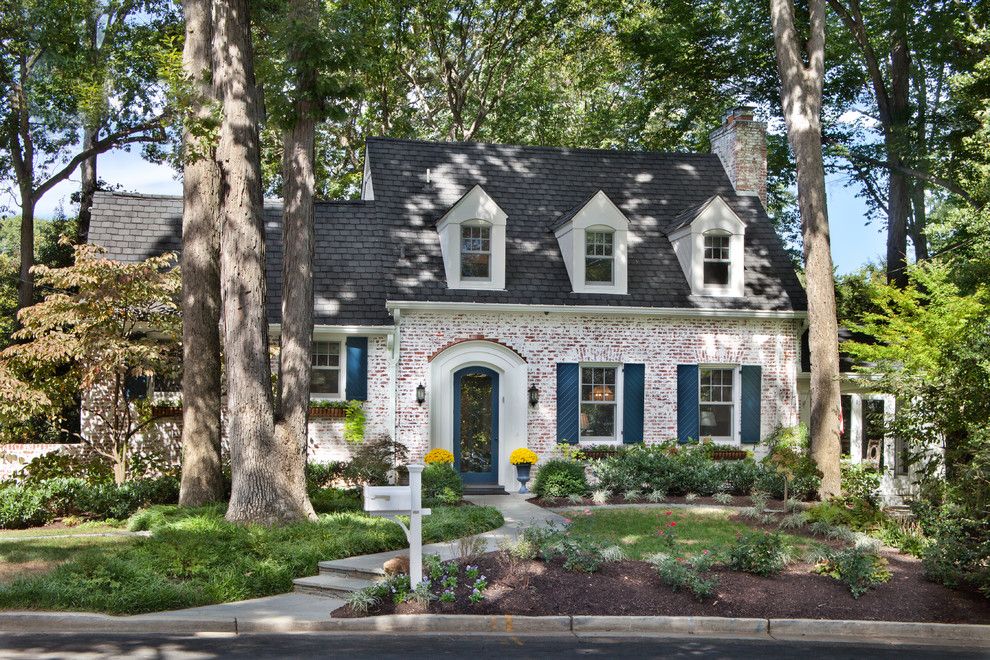 How to Whitewash Brick for a Traditional Exterior with a Shrubs and Trimmed to Perfection by Anthony Wilder Design/build, Inc.