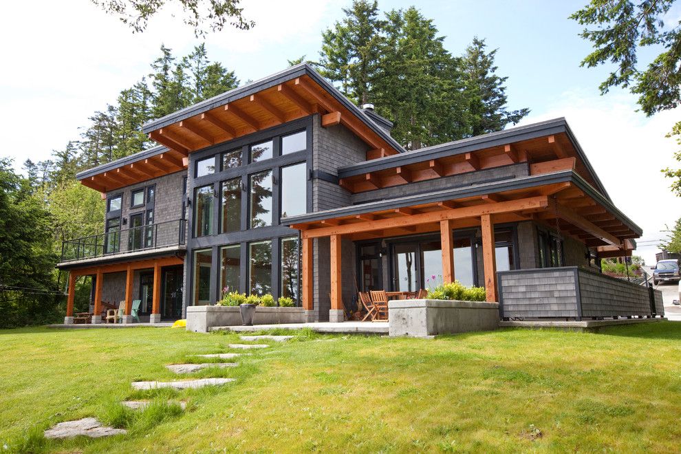 Hurricane Proof House for a Contemporary Exterior with a Rafters and Capturing the Beauty of Its Location. by Island Timberframe Ltd.