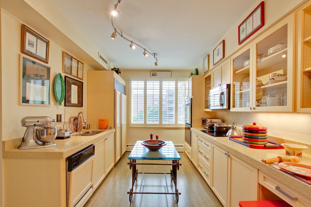 Icestone for a Eclectic Kitchen with a Artwork and Modern Transitional Buttermilk Yellow Kitchen by Reico Kitchen & Bath