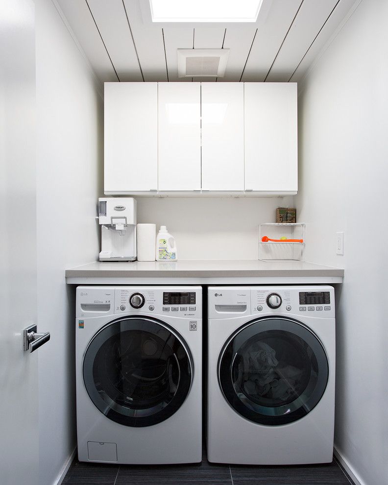 Ikea Akurum for a Midcentury Laundry Room with a Skylight and Double Gable Eichler Remodel by Klopf Architecture