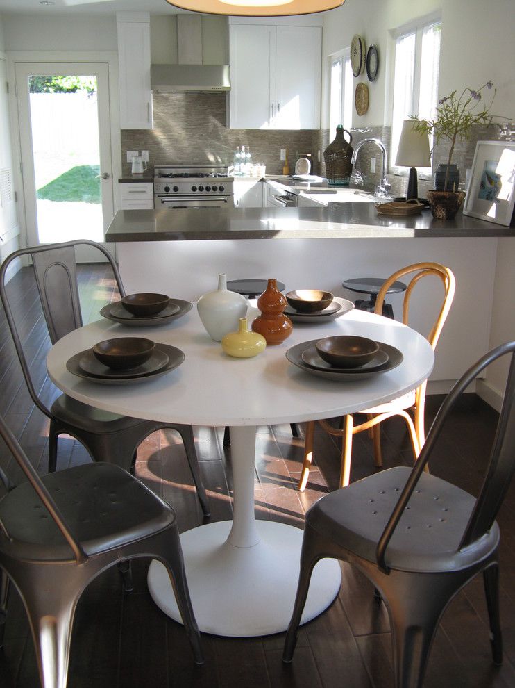 Ikea Bjursta Table for a Eclectic Dining Room with a Tile Backsplash and Saarinen Style Table by Madison Modern Home