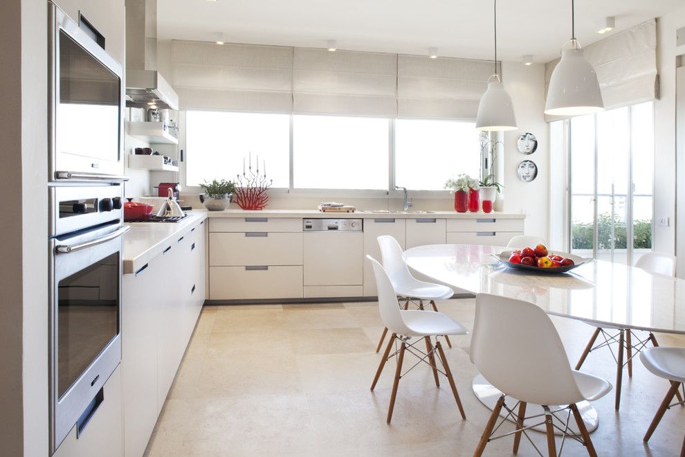 Ikea Bjursta Table for a Modern Kitchen with a White Pendant Lights and Photograper   Aviad Bar Ness, Architect   Karen Goor by Aviad Bar Ness