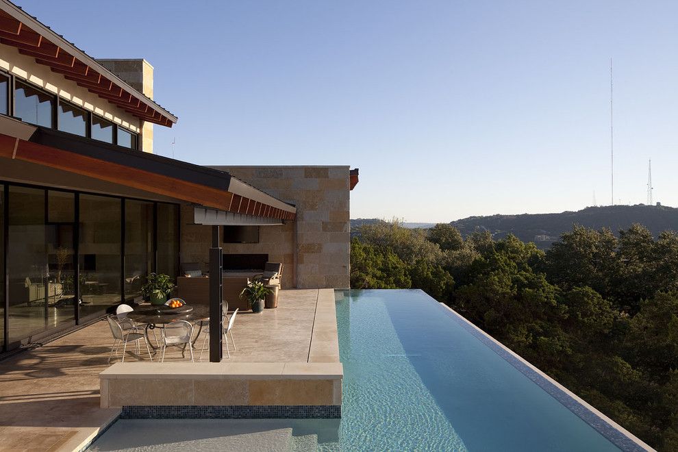 Infinity Edge Pool for a Contemporary Pool with a Hillside and Custom Pool and Spa by Dick Clark + Associates