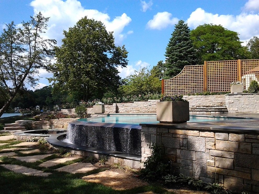 Infinity Edge Pool for a Contemporary Pool with a Rainwall and Lake House Infinity Edge Pool and Integrated Spa by Quantus Pools