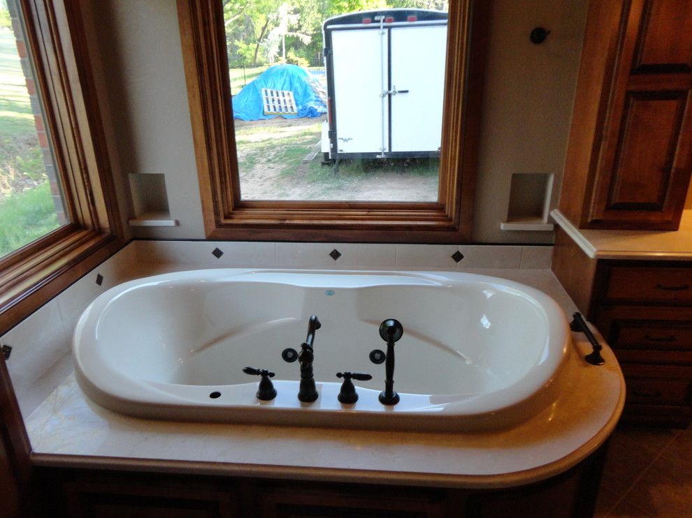 Jetta Tubs for a Traditional Bathroom with a Marble Tub Deck and Master Suite Addition by Birmingham Remodeling and Construction