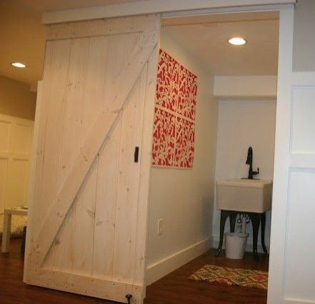 Katos for a Traditional Basement with a Barn Door Laundry Room and Basement Renovation by Christina Katos