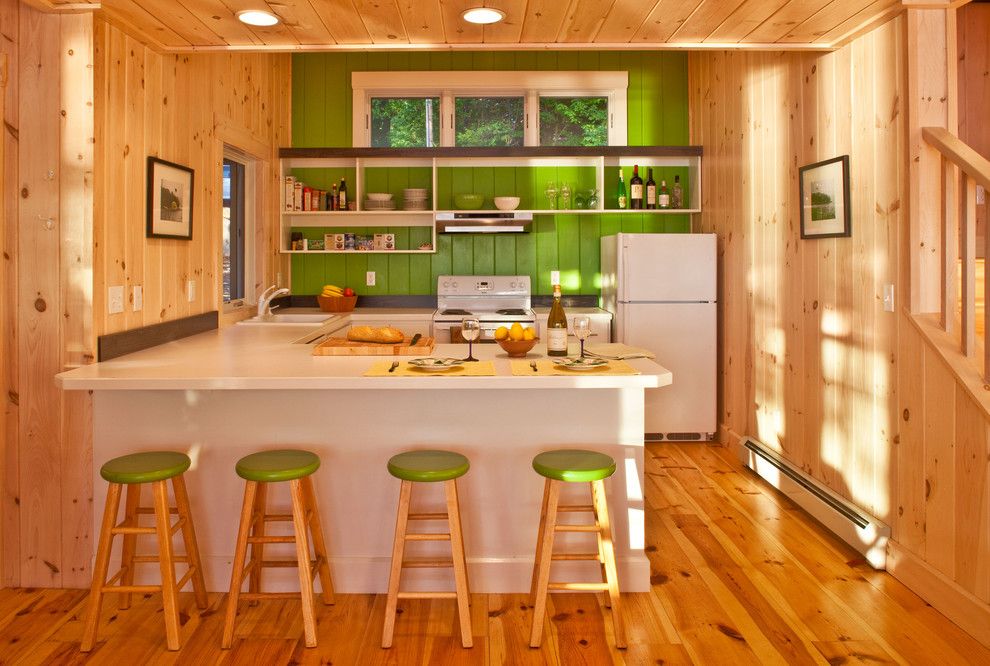 Knotty Pine for a Rustic Kitchen with a Wood Flooring and Highland Lake House Kitchen by Kaplan Thompson Architects