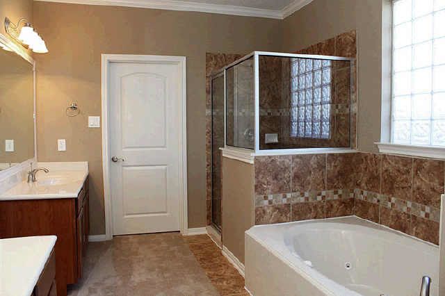 Kurk Homes for a Traditional Bathroom with a Separate Shower and Bathrooms by Kurk Homes