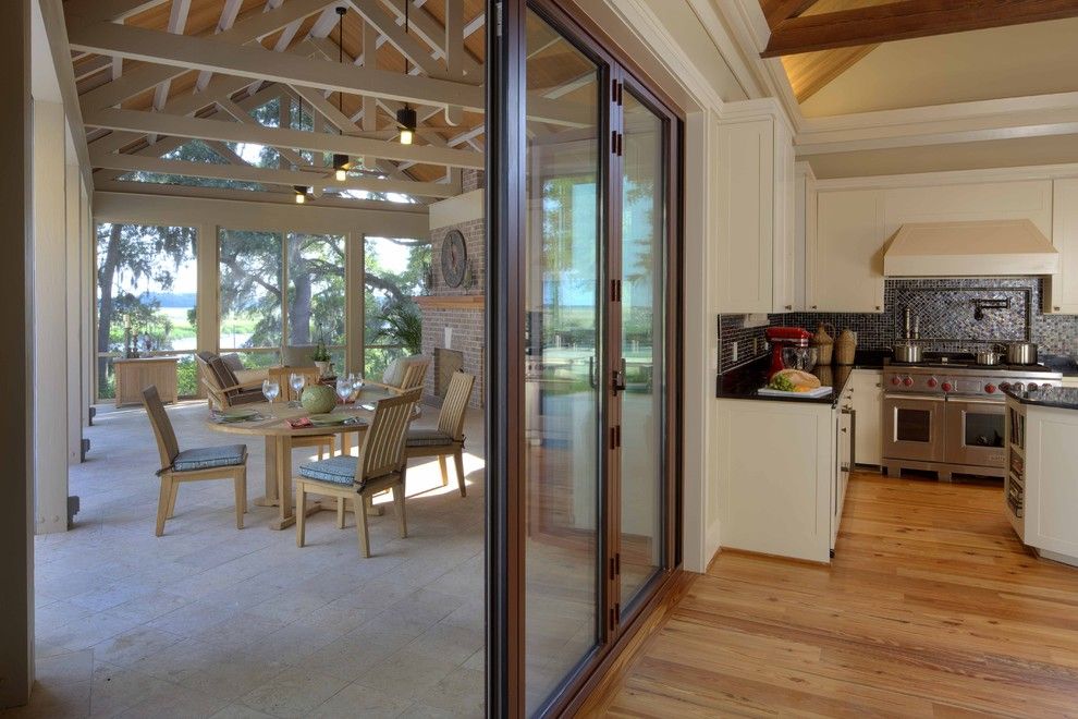 Lanai Porch for a Rustic Kitchen with a Pot Filler and Inside & Outside Kitchens by Frederick + Frederick Architects