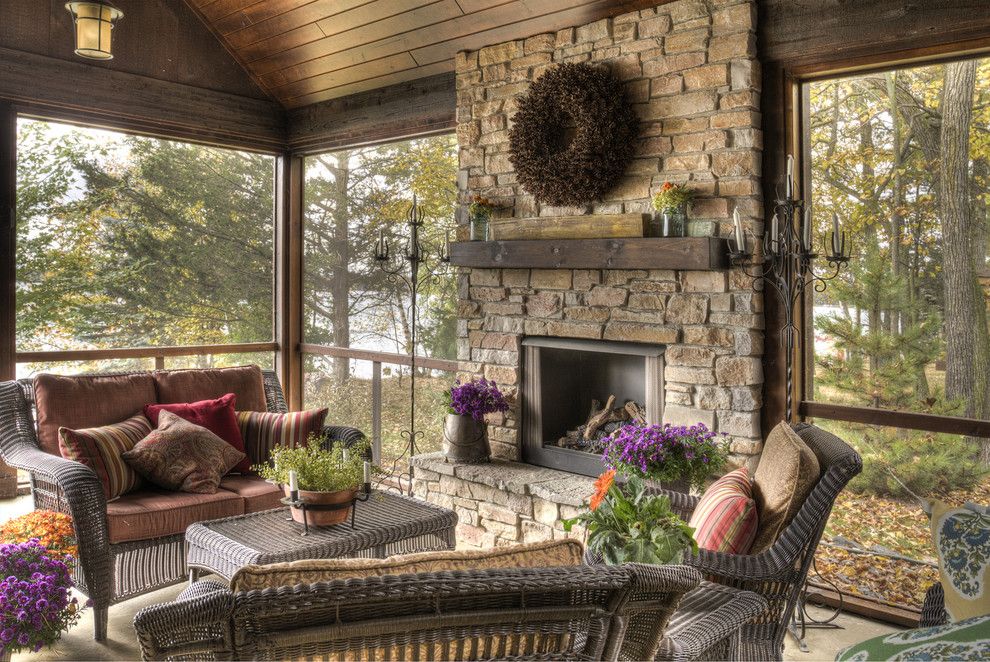 Lanai Porch for a Rustic Porch with a Stone Fireplace Surround and Porch by Lands End Development   Designers & Builders