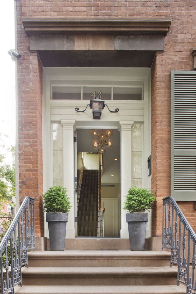 Lantern and Scroll for a Traditional Entry with a Wrought Iron Railing and New York City Townhouse by Dufner Heighes Inc