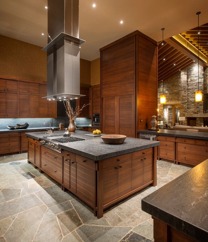 Leathered Granite for a Rustic Kitchen with a Range Hood and Wilderness Retreat by Gregory Carmichael