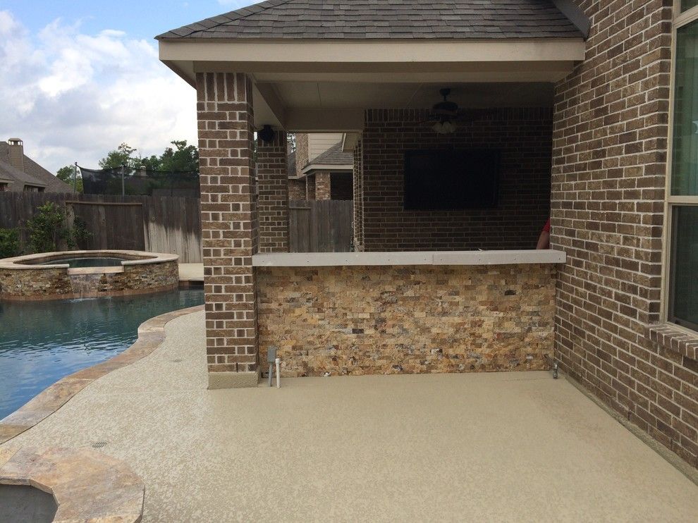 Lowes Memphis for a Rustic Patio with a Beautiful Pools and Houston Outdoor Kitchen with Traeger Grill and Scabos Split Face Stone by Outdoor Homescapes of Houston