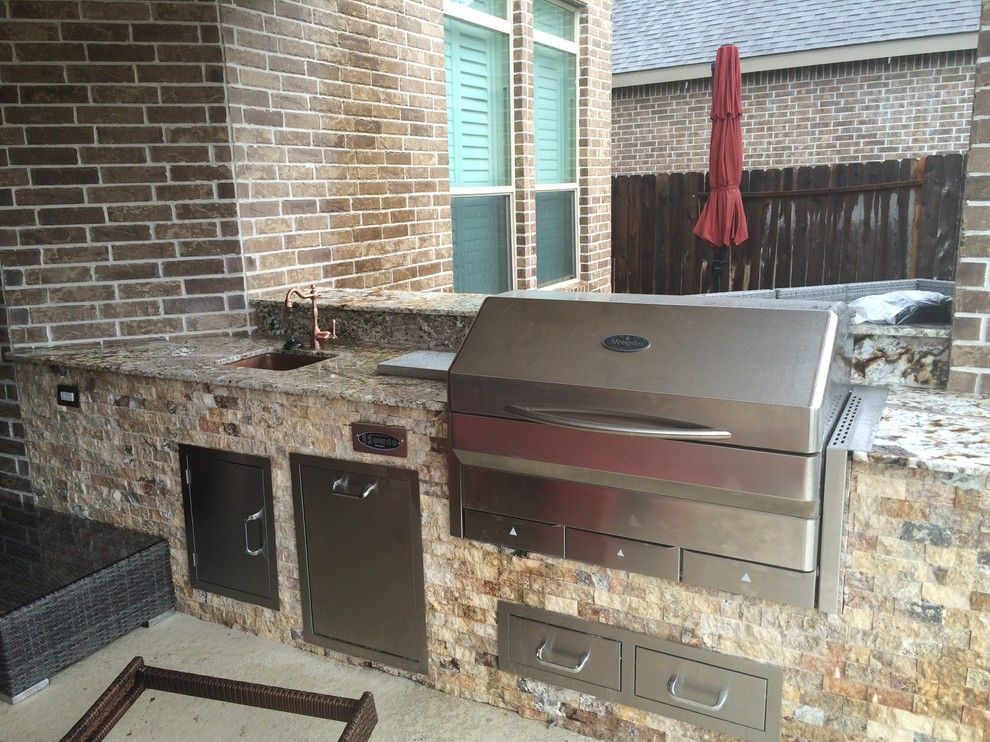 Lowes Memphis for a Rustic Patio with a Normandy and Houston Outdoor Kitchen with Traeger Grill and Scabos Split Face Stone by Outdoor Homescapes of Houston