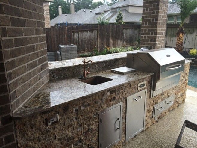 Lowes Memphis for a Rustic Patio with a Split Face Natural Stone and Houston Outdoor Kitchen with Traeger Grill and Scabos Split Face Stone by Outdoor Homescapes of Houston