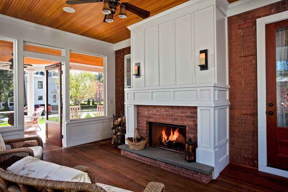 Lowes Raynham Ma for a Traditional Sunroom with a Red Brick Fireplace and Changing History by Teakwood Builders, Inc.