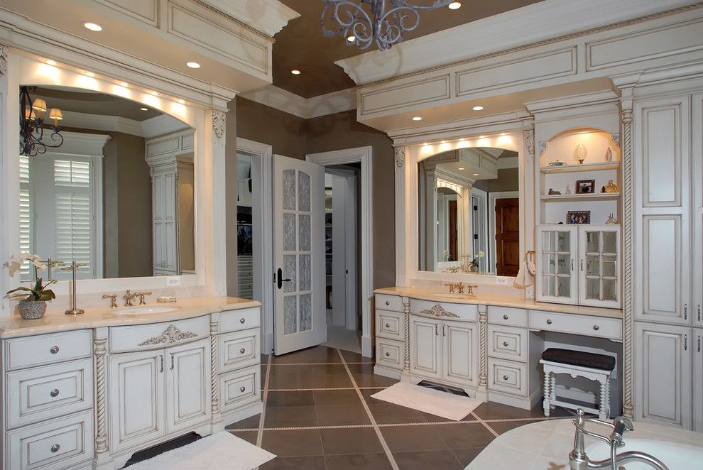 Medallion Cabinets for a Traditional Bathroom with a Bathtub and Bathrooms by Kisarau Architect, Ltd.