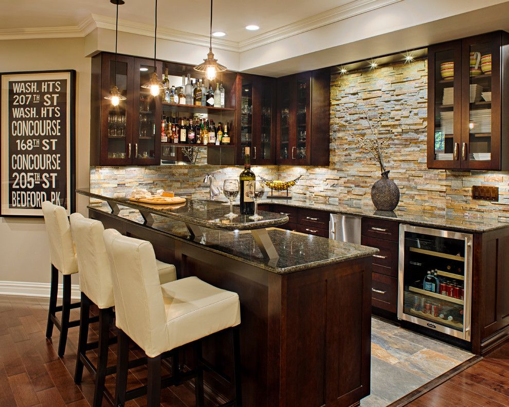Midwest Basement Systems for a Traditional Home Bar with a Dark Wood Cabinets and Modern Marvel by Creative Design Construction, Inc.