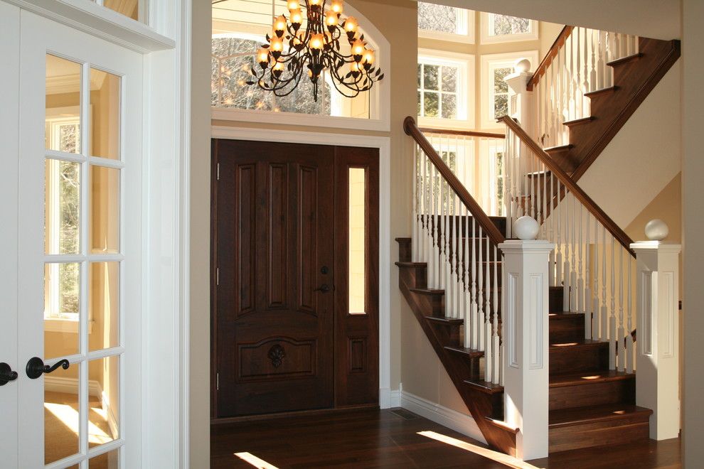 Milliken Doors for a Traditional Entry with a Stair Risers and Staircase with Newels by Thomas & Milliken Millwork, Inc.