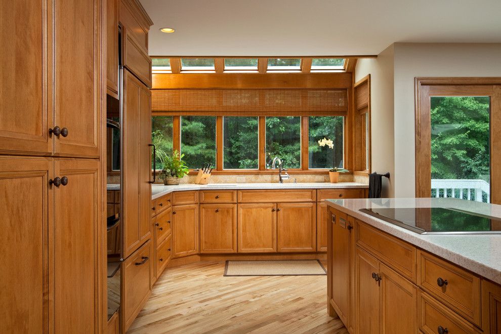 Mullioned Windows for a Traditional Kitchen with a Integrated Refrigerator and Modern Luxury by Teakwood Builders, Inc.