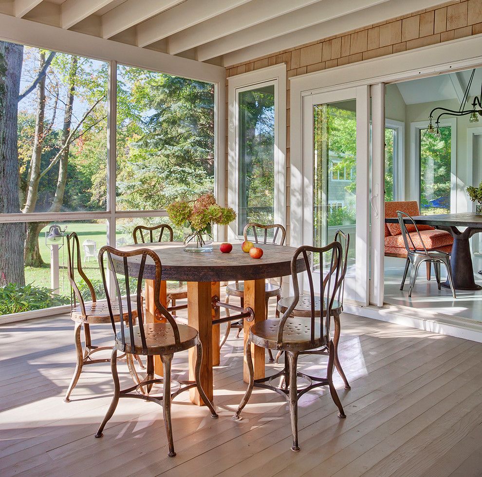 Mundo Tile for a Traditional Porch with a Round Table and Three Oaks Vacation Home by Space Architects + Planners
