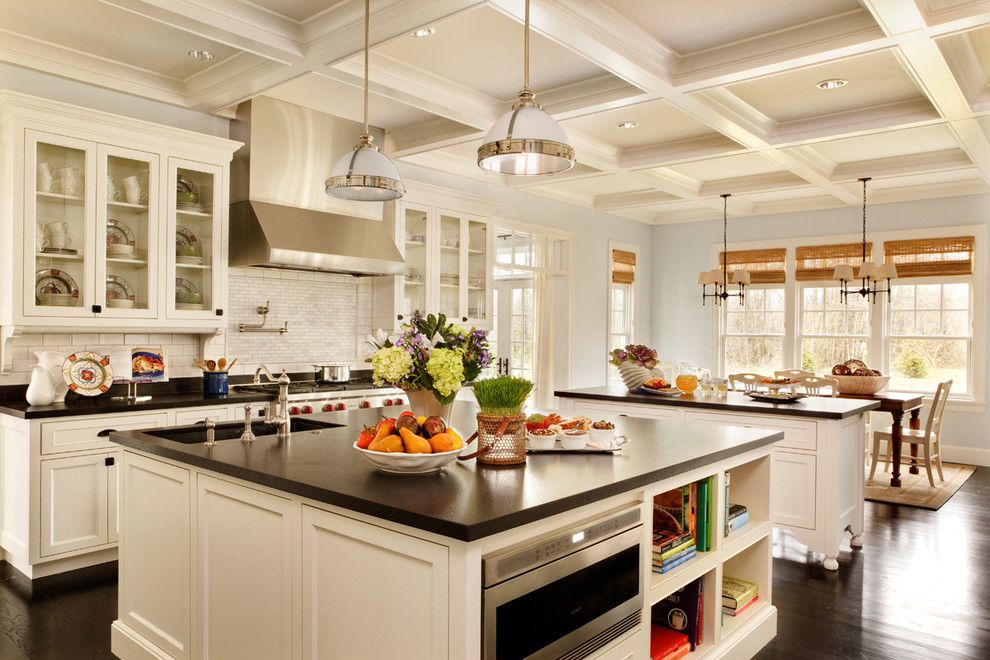 New Caledonia Granite for a Traditional Kitchen with a Dark Wood Floors and Expansive Kitchen by Garrison Hullinger Interior Design Inc.