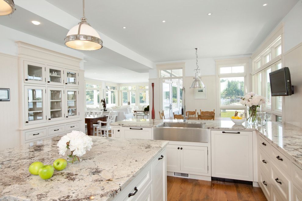 New Caledonia Granite for a Traditional Kitchen with a Farmhouse Sink and Waterfront Estate by Jodi Foster Design + Planning