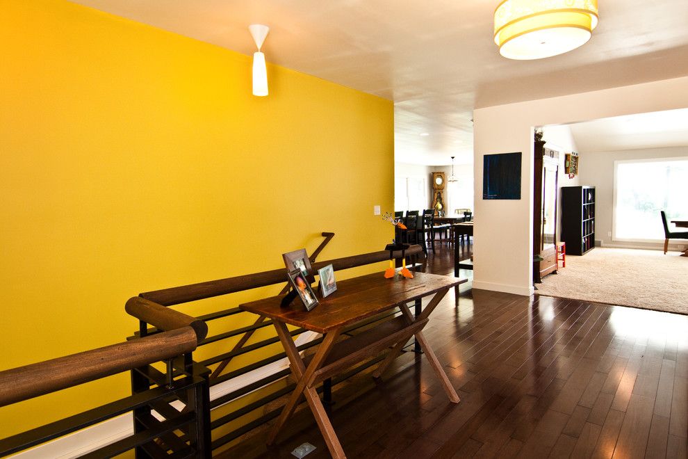 Ochre Color for a Modern Hall with a Color and Living by Noah Herman Sons Builders