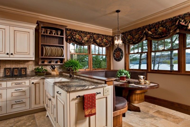 Omega Cabinets for a Traditional Kitchen with a Breakfast Area and Legend of the Lake by Teakwood Builders, Inc.