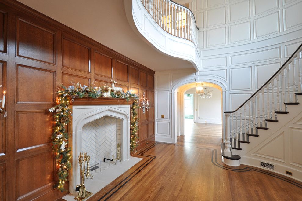 Painted Paneling for a Traditional Living Room with a Dark Stained Wood and Staircases by Anthony James Construction