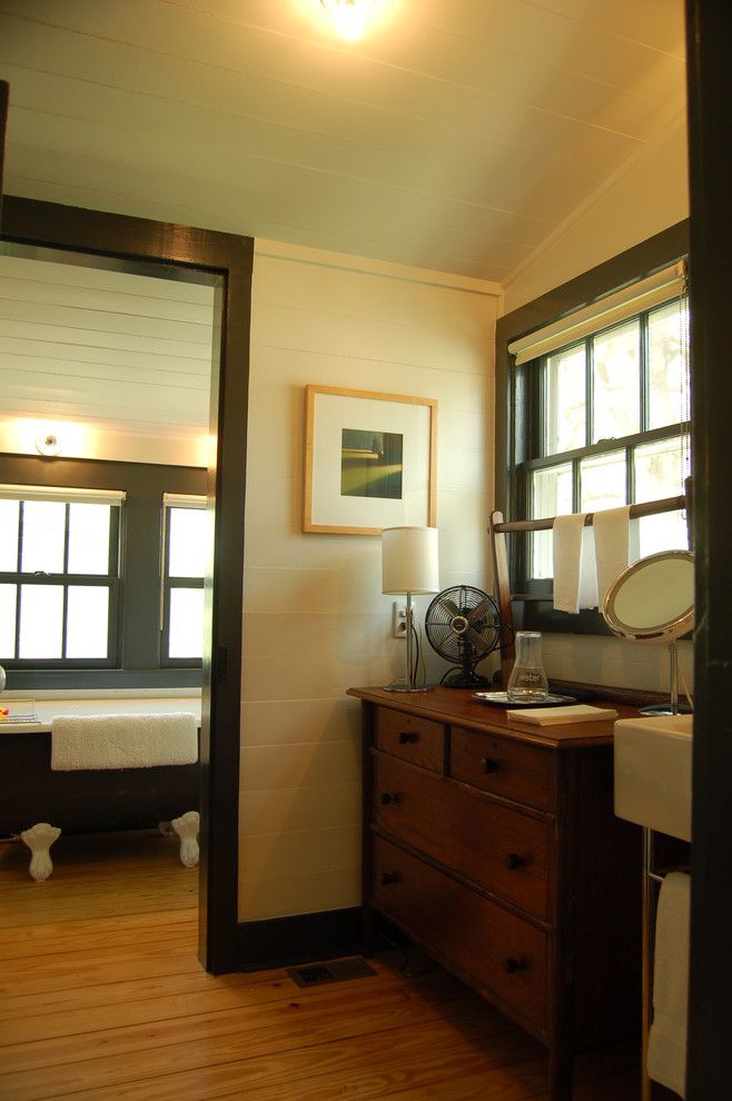 Painted Wood Paneling for a Farmhouse Bathroom with a Claw Foot Tub and Historic House by Tim Cuppett Architects