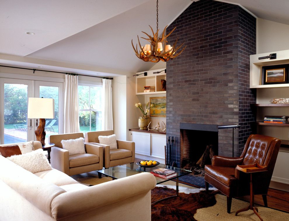 Painting Brick Fireplace for a Farmhouse Family Room with a Sloped Ceiling and Family Room by Paul Rice Architecture