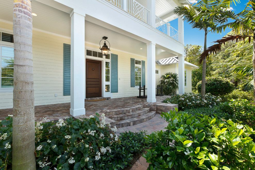 Paver Steps for a Tropical Porch with a Landscape and West Indies House Design by Weber Design Group, Inc.