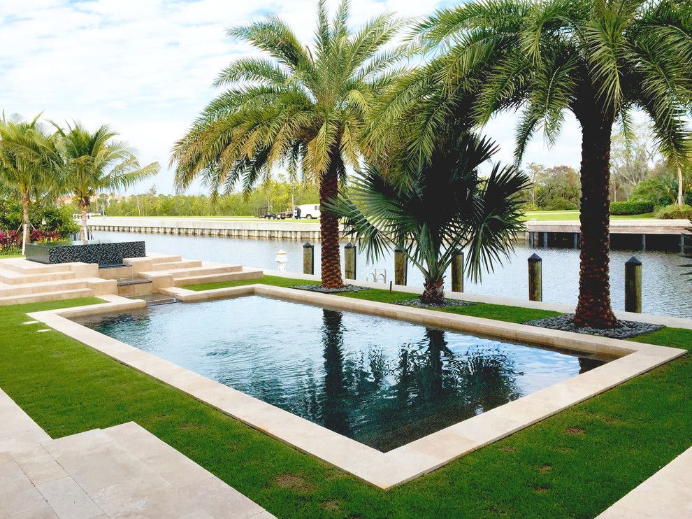 Pebble Tec for a Tropical Pool with a Water View and Our Work by Champion Pools & Spas, Inc.