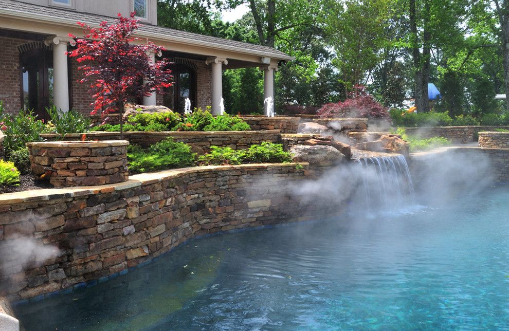 Pebbletec for a Traditional Pool with a Waterslide and Eads Natural Pool & Backyard Resort by J. Brownlee Design