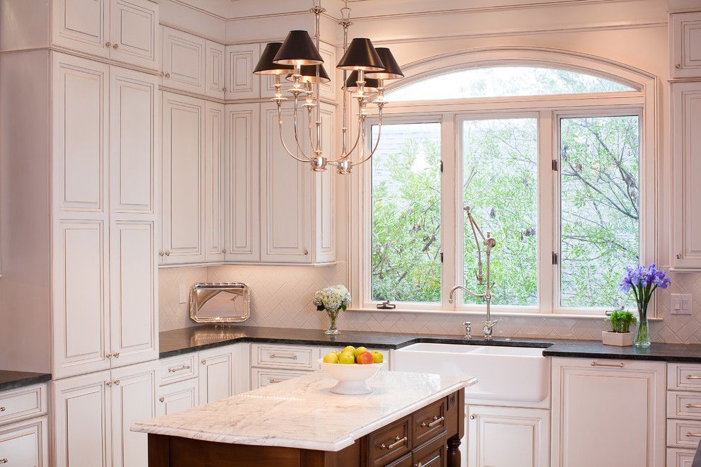 Pental for a Traditional Kitchen with a Arched Window and Kitchen + Bath Artisans by Kitchen + Bath Artisans