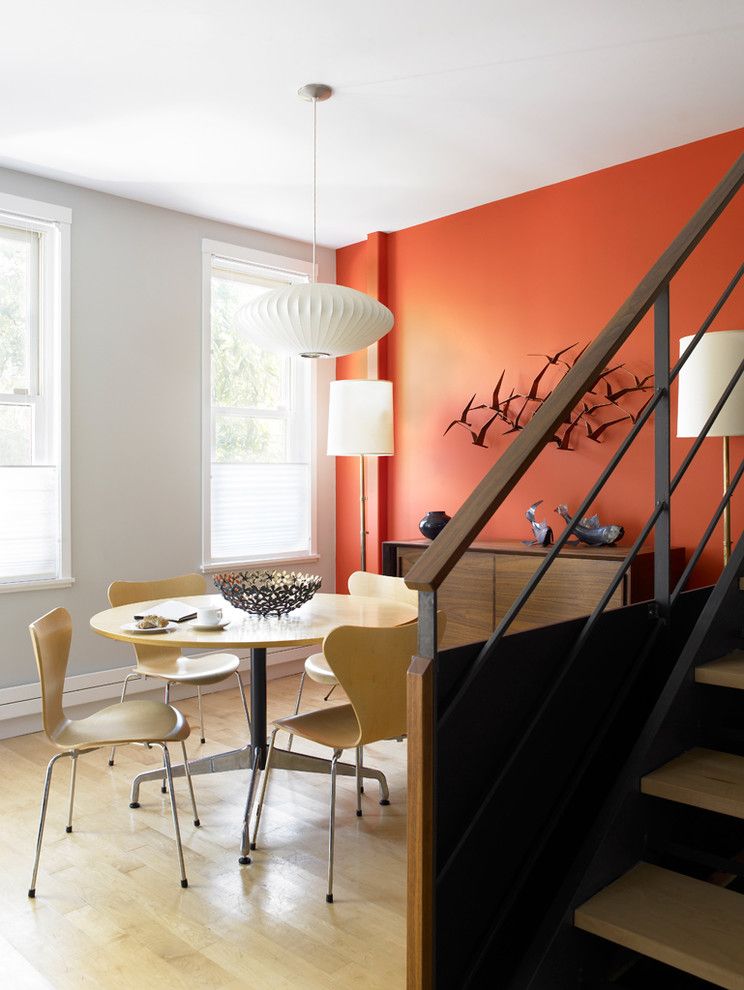 Persimmon Color for a Midcentury Dining Room with a White Painted Trim and Carroll Gardens Abode by Cwb Architects