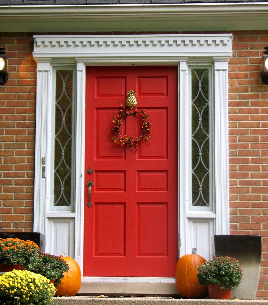 Pineapple Symbolism for a Traditional Exterior with a Wall Panneling and Red Front Door with Pineapple Knocker by Threeboys