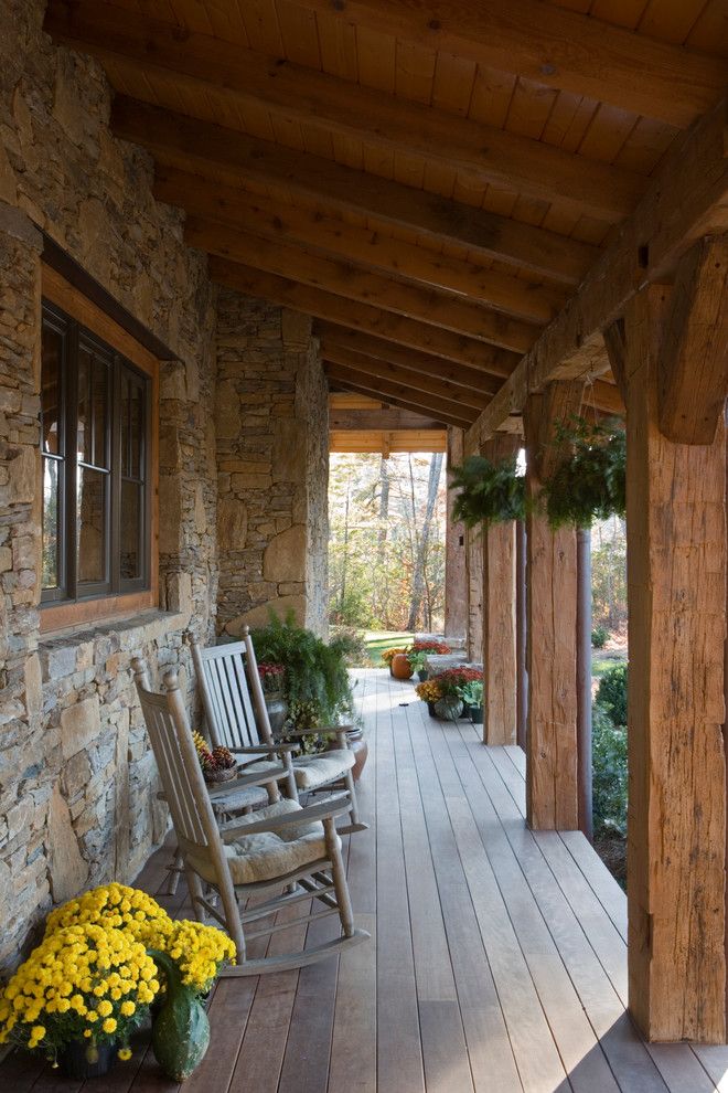 Pirch for a Rustic Porch with a Stone Wall and Stone and Reclaimed Timber Mountain Estate by Mosscreek