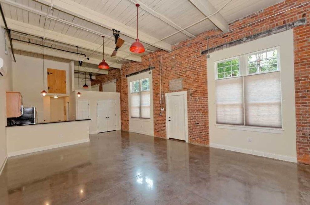 Playroom Ideas for a Industrial Living Room with a Exposed Beams and Window Factory Lofts by Viscusi Builders Ltd.