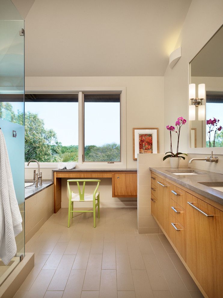 Poured Concrete Countertops for a Contemporary Bathroom with a Beige Tile Floor and North Peak by Furman + Keil Architects