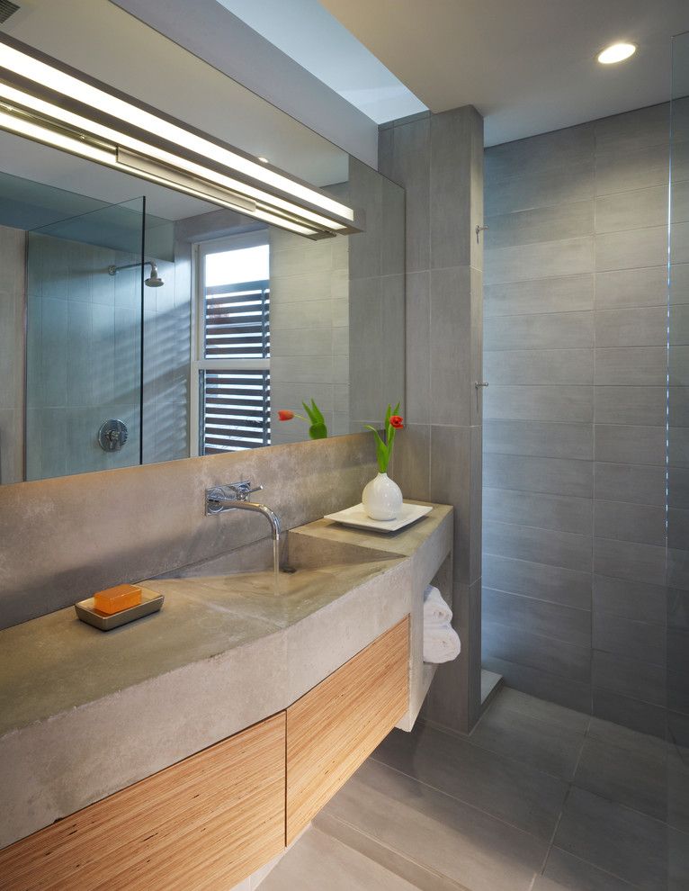 Poured Concrete Countertops for a Industrial Bathroom with a Recessed Lighting and Ricon Bates by Studio Twenty Seven Architecture