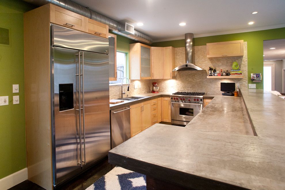 Poured Concrete Countertops for a Modern Kitchen with a Maple Cabinets and Vanderbilt by Modern Craft Construction, Llc