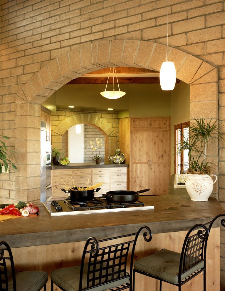 Poured Concrete Countertops for a Rustic Kitchen with a Arched Doorway and Blue House by Silva Studios Architecture