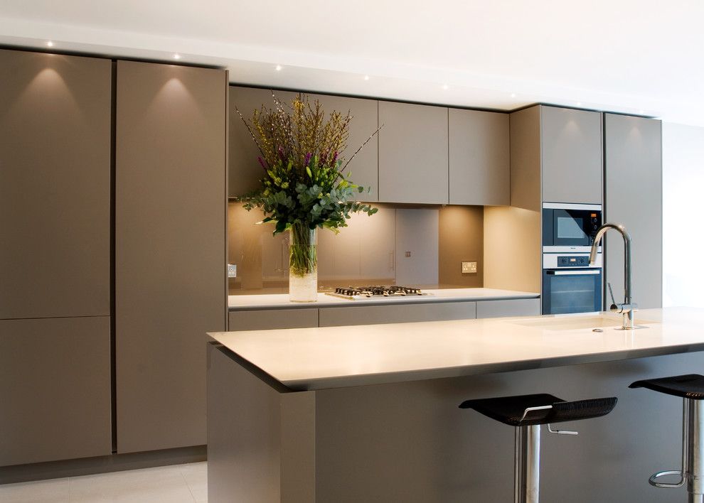 Precision Countertops for a Contemporary Kitchen with a Kitchen Island and Open Plan Handleless Kitchen by Neil Norton Design