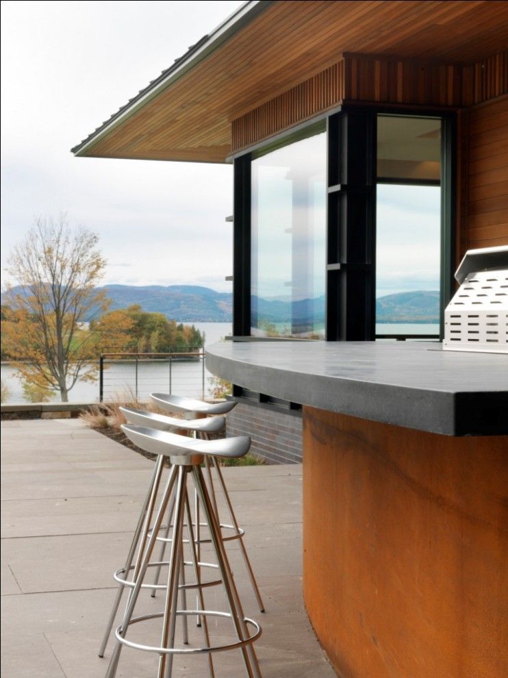 Quaker Windows for a Beach Style Patio with a Waterfront and Quaker Bluff Residence by Birdseye Design